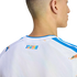 A close-up of the back of a man's neck and upper back, wearing a white jersey with blue trim and a colorful "SIN FRONTERAS" graphic on the neck.