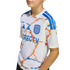 A youth wearing a white soccer jersey with an orange and blue marbled pattern, featuring the San Diego FC crest and DIRECTV logo on the chest.