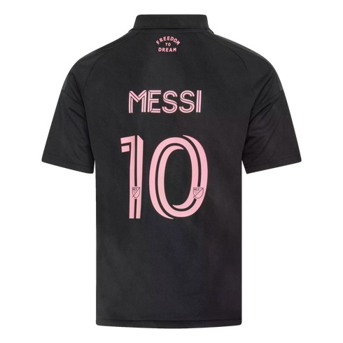 Back view of a black soccer jersey with pink text reading "MESSI" and a large number 10. The words "FREEDOM TO DREAM" are printed in pink near the collar.