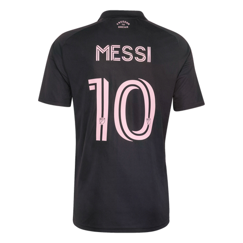 Back of a black Inter Miami soccer jersey featuring the name "MESSI" and number "10" in pink. Small "FREEDOM TO DREAM" text is printed near the collar.