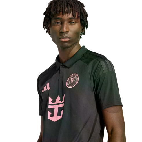 Young man with dreadlocks in a black and pink Inter Miami CF jersey featuring the Adidas, team crest, and Royal Caribbean logos, against a black background.