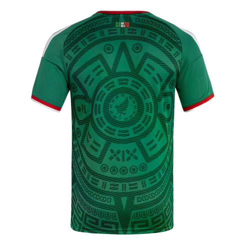 Back view of a green Mexico soccer jersey with a large, dark green Aztec sun stone graphic and red and white trim on the collar and sleeves.