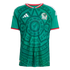 A green Mexico soccer jersey with an intricate dark green Aztec-style pattern, white Adidas logo, Mexico crest, and red and white trim on the collar and sleeves.