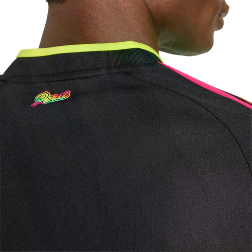 Close-up of a black Peru jersey back with a vibrant multicolored "Peru" logo, neon yellow collar trim, and pink shoulder stripes.