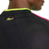 Close-up of a black Peru jersey back with a vibrant multicolored "Peru" logo, neon yellow collar trim, and pink shoulder stripes.
