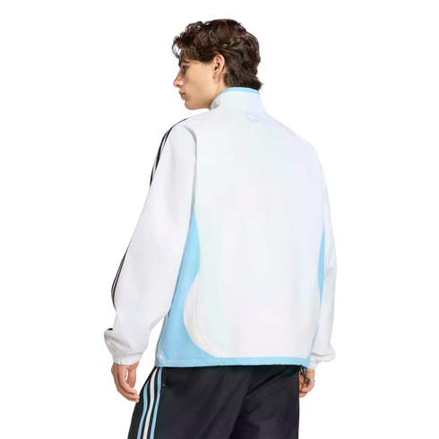 Rear view of a man in a white and light blue track jacket and black track pants with light blue stripes, set against a black background.
