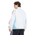 Rear view of a man in a white and light blue track jacket and black track pants with light blue stripes, set against a black background.