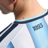 Close-up of a person's neck and shoulder wearing a light blue and white striped jersey with "1893" printed on the back collar area.