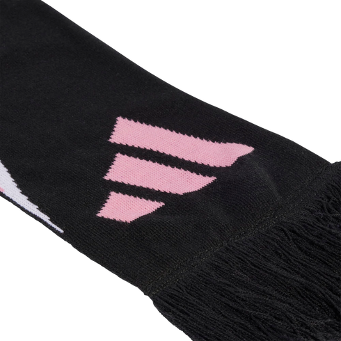 Close-up of a black knit scarf featuring a pink three-stripe logo and black fringe at the end.