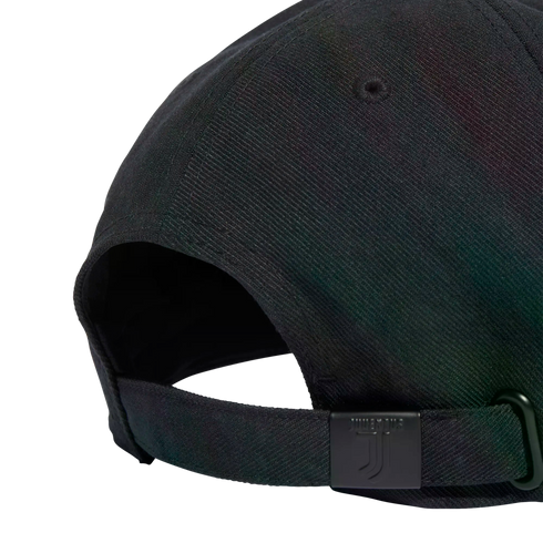 Close-up of the back of a black baseball cap featuring an adjustable strap with a metal slider embossed with the Juventus FC logo.