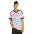 A man wearing a light blue and pink patterned Adidas Belgium soccer jersey with a black collar, set against a black background.