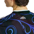 Close-up of the back of a black Argentina soccer jersey featuring vibrant blue and purple swirls and an Argentina sun logo on the neck.