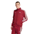 A young man models a maroon Adidas tracksuit with white stripes and an Arsenal FC cannon logo against a black background.