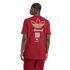 Rear view of a man in a maroon Adidas t-shirt featuring an off-white trefoil logo, "Arsenal" script, three vertical bars, and a cannon emblem.