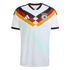 White Germany home football jersey featuring a black, red, and gold geometric chest design, Adidas logo, and team crest with four stars.