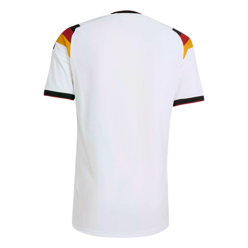 Back view of a white short-sleeved soccer jersey with German flag colors (black, red, and gold) on the shoulders and cuffs, set against a black background.