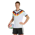 A person in a German national team soccer uniform poses with a soccer ball against a black background.