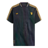 Black Manchester United soccer jersey with purple pinstripes. It features gold shoulder stripes, a gold Adidas trefoil logo, and a gold club crest on the chest.