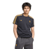 A man models a navy pinstriped Manchester United jersey and grey trousers against a black background.