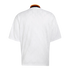 Back view of a white short-sleeve jersey featuring a subtle tonal pattern and a ribbed collar with black, red, and yellow stripes.