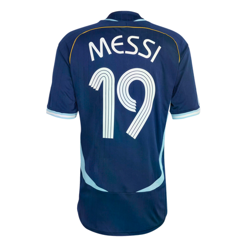Back of a navy blue soccer jersey featuring the name "MESSI" and number "19" in white. The jersey has light blue trim and subtle vertical stripes, set against a black background.