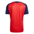 Back view of a red sports jersey with navy blue sleeves, featuring yellow vertical stripes and the word "España" printed in gold below the neckline.