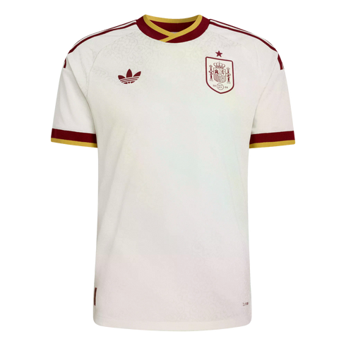 A white Adidas Spain national football team jersey with burgundy and gold trim, featuring a subtle floral pattern, trefoil logo, and national team crest.