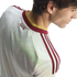 Profile of a man wearing a white Spain football jersey with maroon and gold trim and "España" embroidered on the back neck.