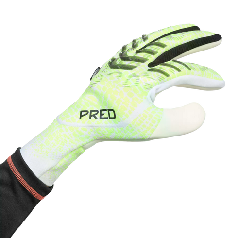 A lime green and white soccer goalkeeper glove with black textured grip ridges and "PRED" text on the back of the hand, shown against a black background.