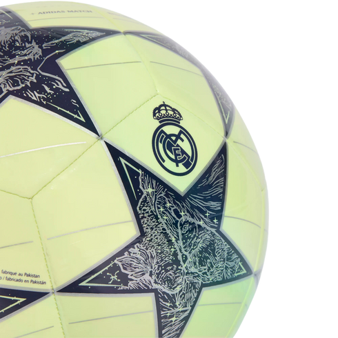 Close-up of a lime green soccer ball featuring the Real Madrid crest and Champions League star pattern with intricate graphics.
