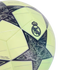 Close-up of a lime green soccer ball featuring the Real Madrid crest and Champions League star pattern with intricate graphics.