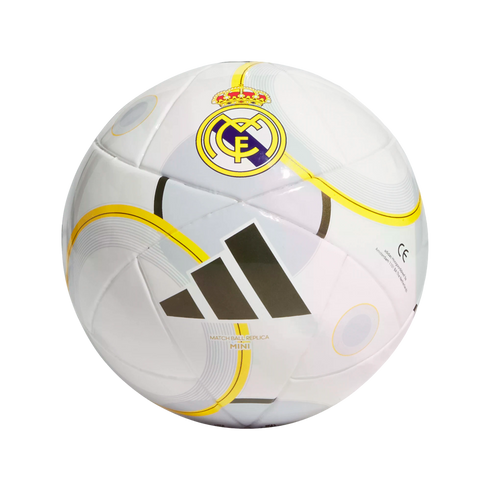 A white Adidas mini replica soccer ball featuring the Real Madrid club crest, black three-stripe logo, and yellow accents.
