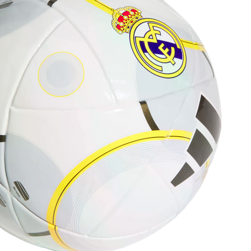 A white soccer ball featuring the Real Madrid club crest, the Adidas logo, and yellow and grey circular graphic patterns.