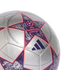 Close-up of a silver Adidas UEFA Champions League soccer ball featuring large purple stars with orange outlines and intricate graphics.