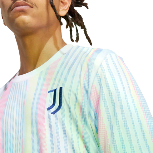 A person wears a Juventus soccer jersey featuring pastel-colored vertical stripes and the team's "J" logo on the chest.