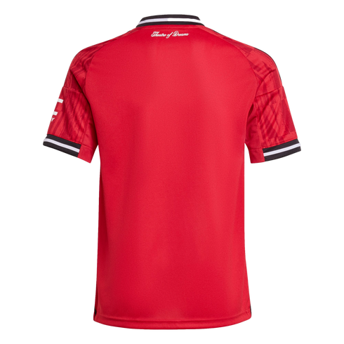 The back of a red Manchester United football shirt with black and white striped collar and cuffs. "Theatre of Dreams" is written in white cursive below the neckline.