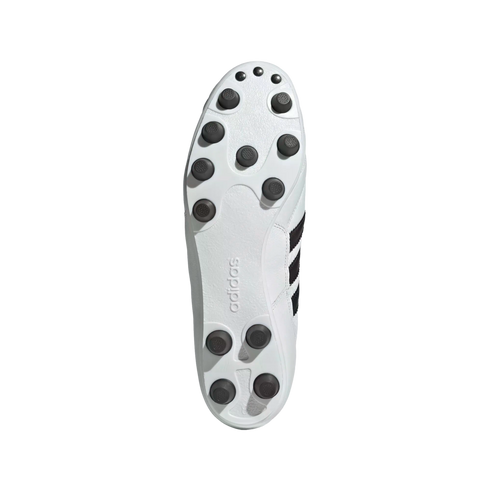 Sole of a white Adidas soccer cleat with black traction studs, shown against a solid black background.