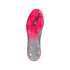 Bottom view of a pink and silver soccer cleat with "MESSI" branding on the soleplate and clear traction studs.