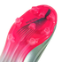 Close-up of a vibrant pink and silver soccer cleat sole with clear studs and "MESSI" branding.