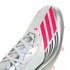 Close-up of a silver Adidas soccer cleat featuring vibrant pink stripes, "MESSI" branding, and white laces.