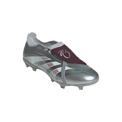 Silver metallic soccer cleat with a maroon fold-over tongue and maroon/white stripes, isolated on a white background.