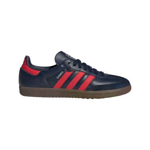 Profile view of a navy blue Adidas Samba sneaker with three red stripes and a gum sole.