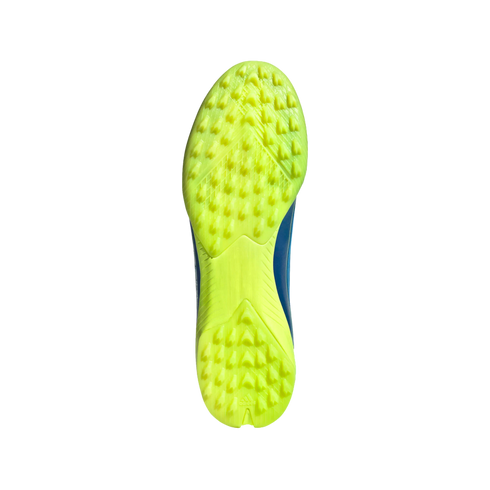 Bottom view of a neon yellow turf soccer shoe featuring a multi-studded rubber outsole for traction.