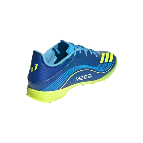 A blue and neon yellow Adidas Messi soccer turf shoe seen from a rear-side angle. It features the "MESSI" name on the side and a studded neon yellow sole.