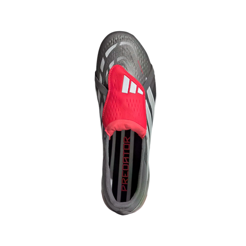 Top-down view of a grey and black Adidas Predator soccer cleat with a red fold-over tongue and white logo. The name "PREDATOR" is visible on the insole.