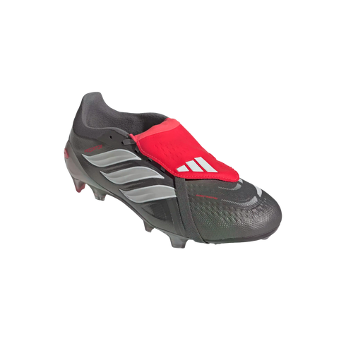 A grey and black Adidas Predator soccer cleat with silver stripes and a red fold-over tongue featuring a white logo, isolated on a black background.