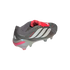 Gray Adidas Predator soccer cleat with white stripes, a prominent red fold-over tongue, and translucent studs, isolated on black.