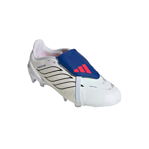 White Adidas Predator soccer cleat with black stripes and a blue fold-over tongue featuring a red logo, held by a white elastic strap, isolated on a black background.