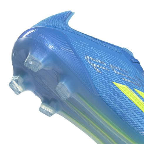 A close-up shot of the heel and translucent blue soleplate of a bright blue soccer cleat against a solid black background. The semi-transparent soleplate features clear integrated studs and embossed "SPEEDFRAME 360" text, with partial yellow accents visib