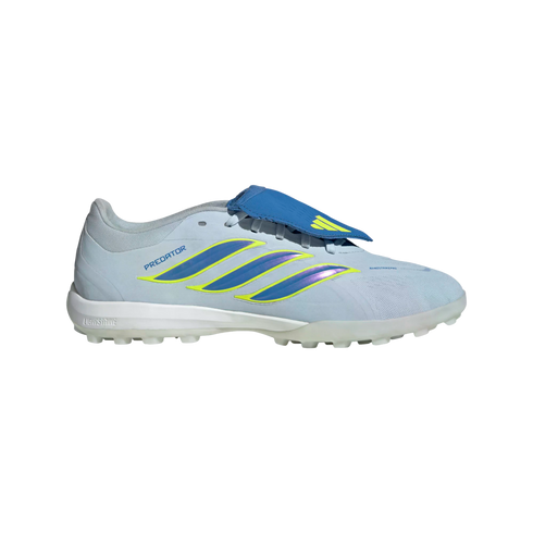 A side profile of a light blue Adidas Predator turf soccer shoe on a black background. The shoe features three iridescent blue and purple stripes with neon yellow outlines along the side. It has a royal blue fold-over tongue, a white midsole, and a transl